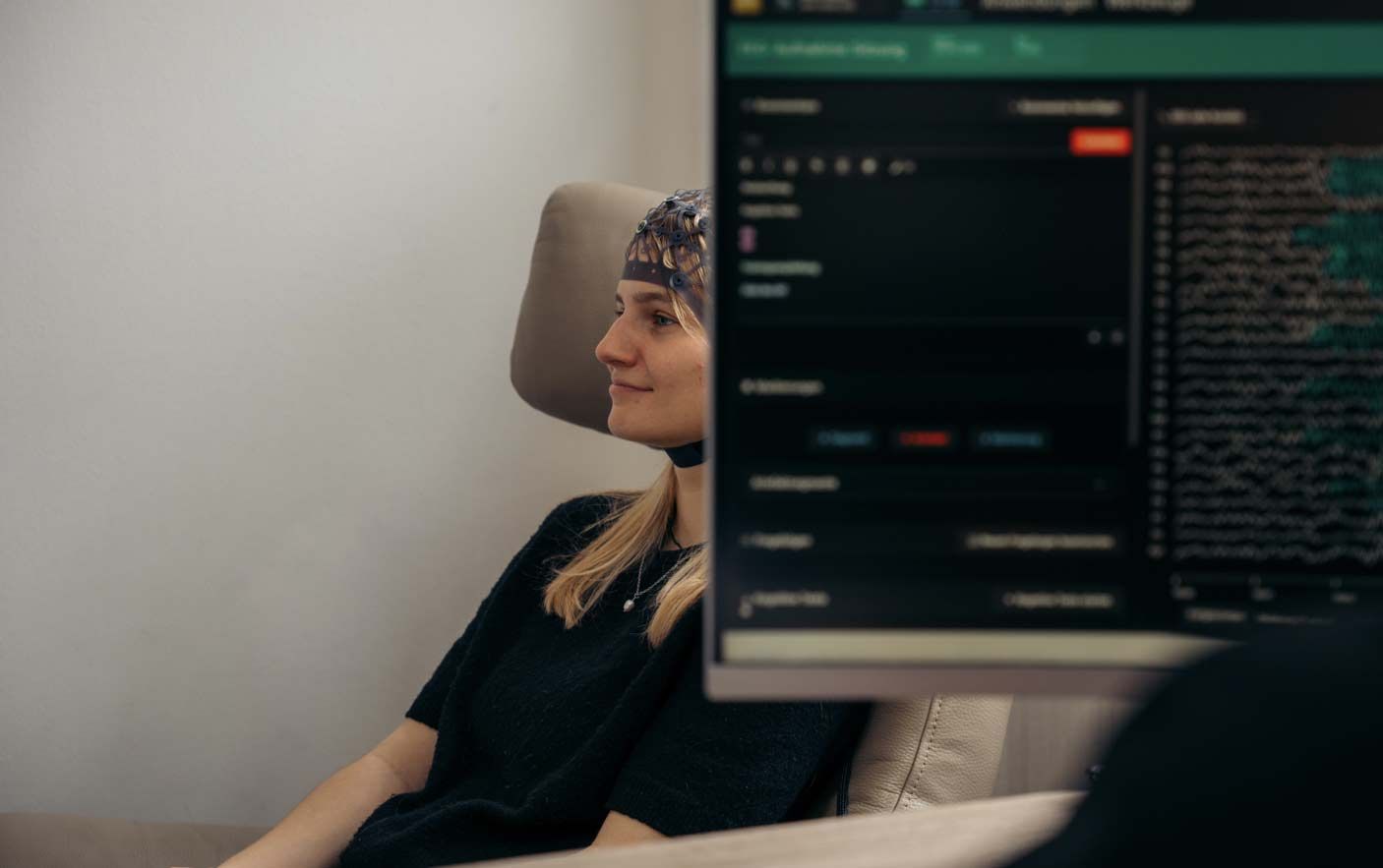 A client wearing the QEEG gel-free sensor cap during an in-clinic mapping session