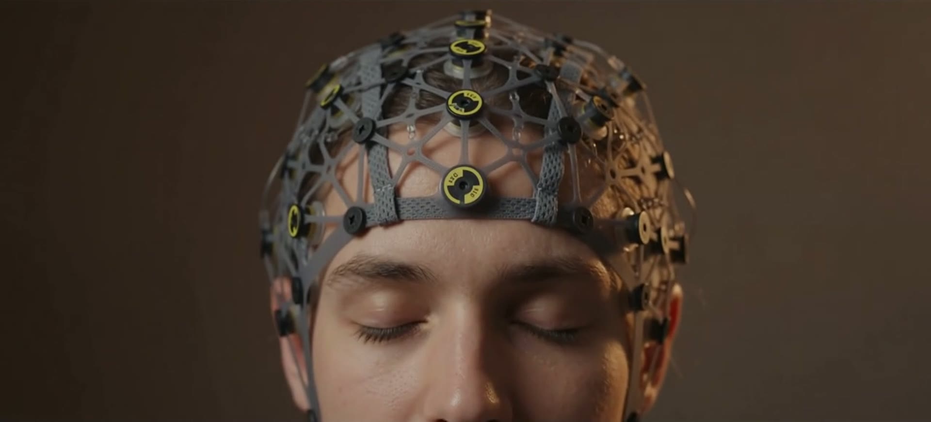 A person wearing a QEEG sensor cap during a brain mapping session